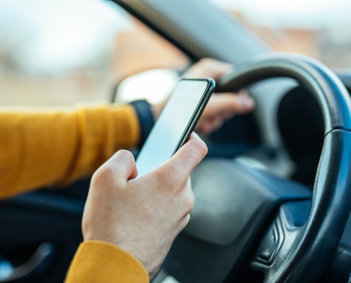 Shot of a male using mobile phone while driving the car.