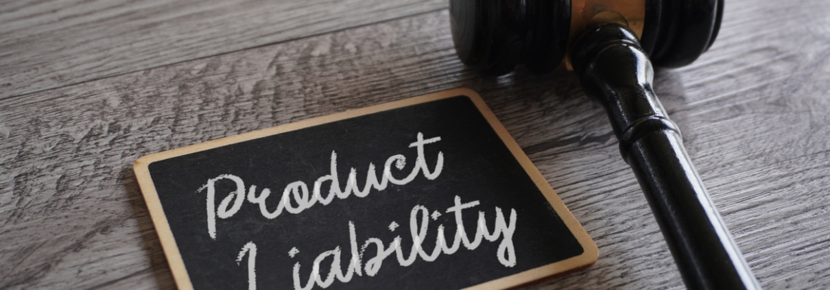 Closeup image of judge gavel and text PRODUCT LIABILITY on table.