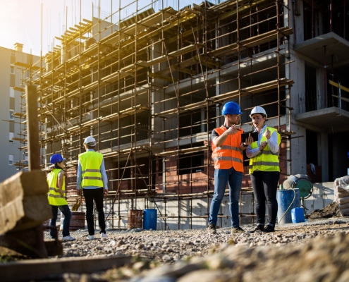 Four construction workers having meeting