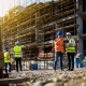 Four construction workers having meeting