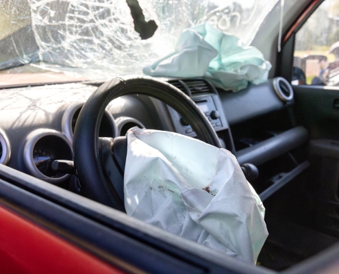 A deployed air bag and broken windshiled