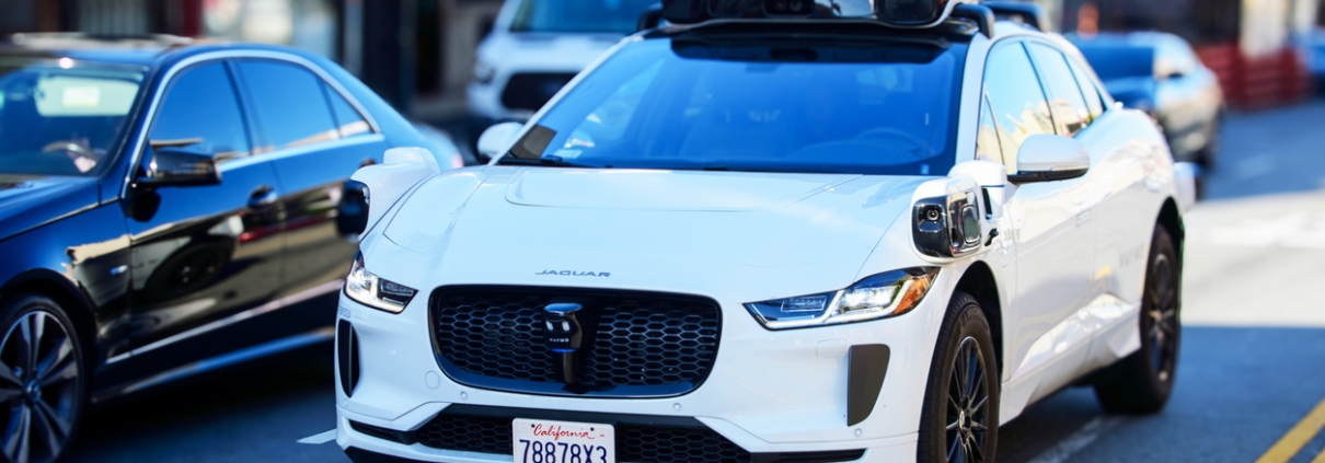 Waymo Jaguar driverless car drives on urban street in San Francisco