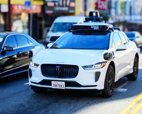 Waymo Jaguar driverless car drives on urban street in San Francisco