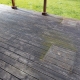Weathered wooden deck, terrace with algae and moss, spring cleaning in garden and yard