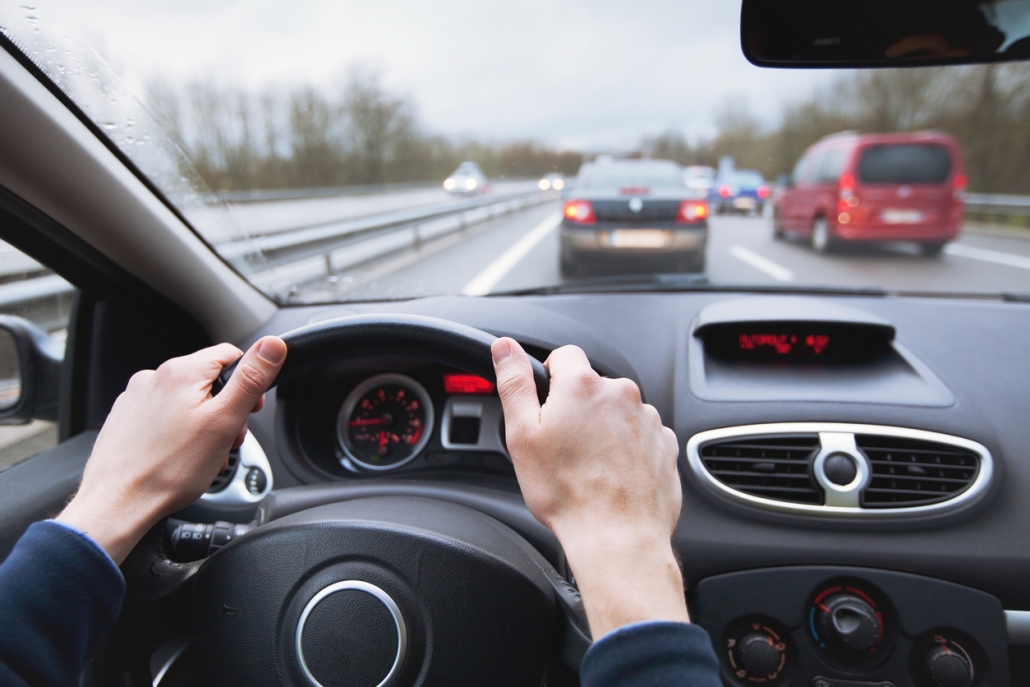 driving car on highway, close up of hands on steering wheel