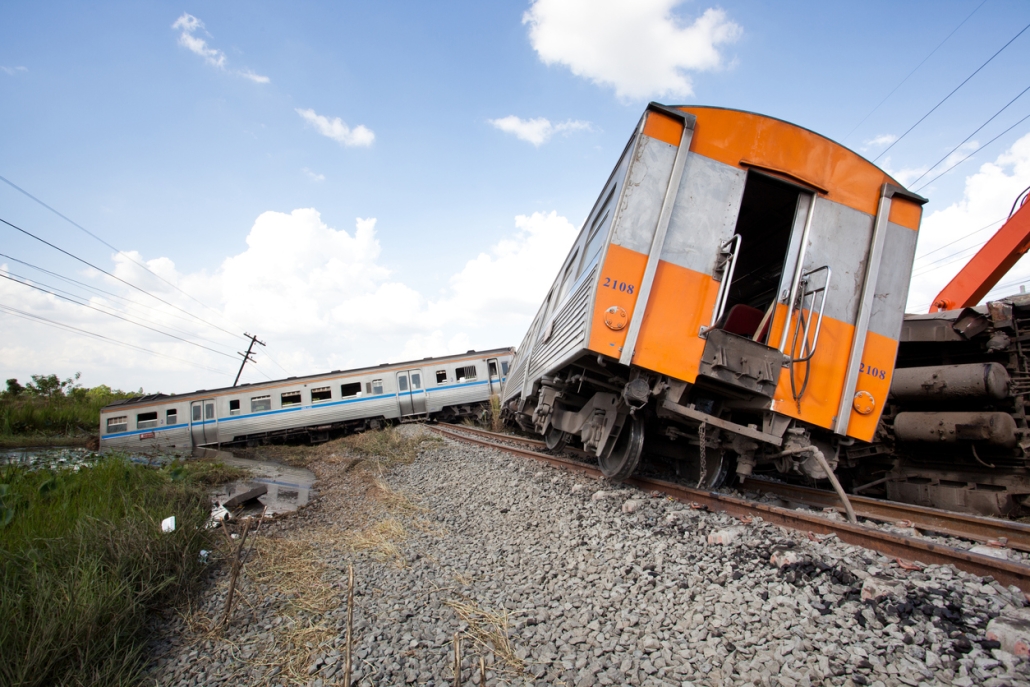 a train car derailing on the track right next to powerlines.