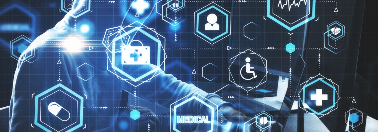 Hacker using computer with glowing blue medical interface. Medicine and technology concept.
