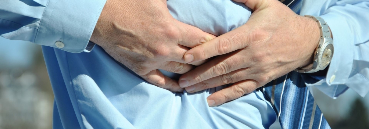 man grabbing his abdomen