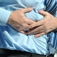 man grabbing his abdomen