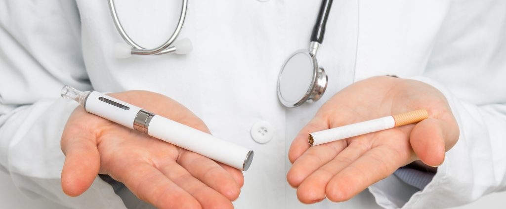 doctor holding a vape and a cigarette