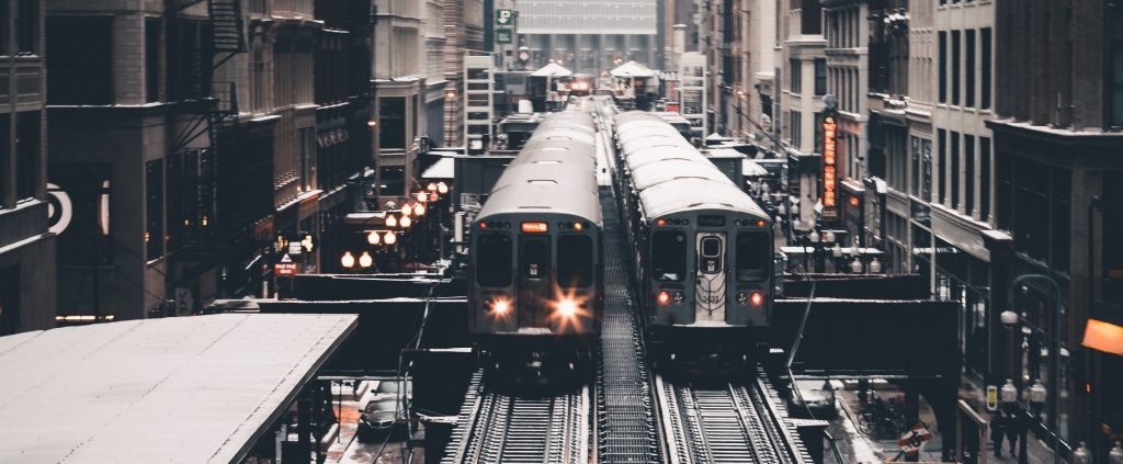trains passing each other between buildings
