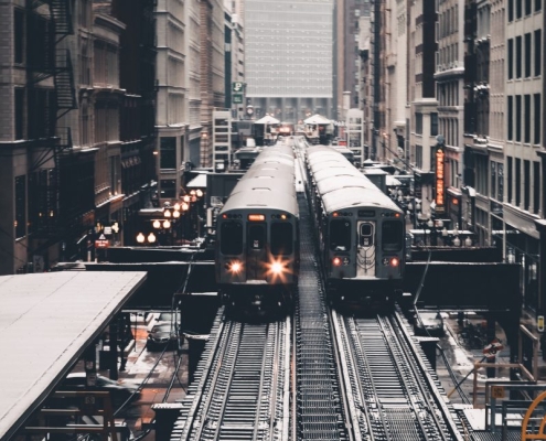 trains passing each other between buildings