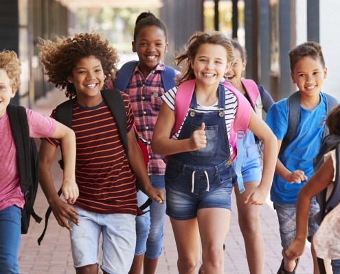 group of school kids running