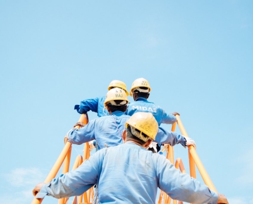 workers climbing a ladder