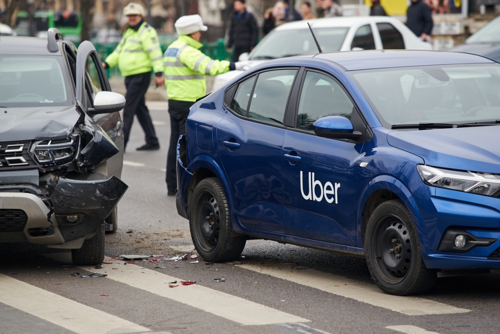 An Uber logo branded car on the road at the place where it was involved in a car accident. This image is for editorial use only.