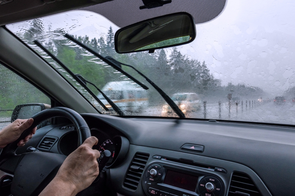 Blurred silhouettes of vehicles. Inside view of the car