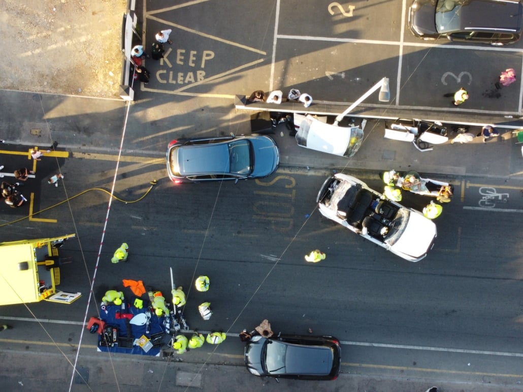 Car accident between two cars seen in aerial view.