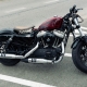 Contemporary motorcycle with shiny surface parked on parking in urban area on overcast day