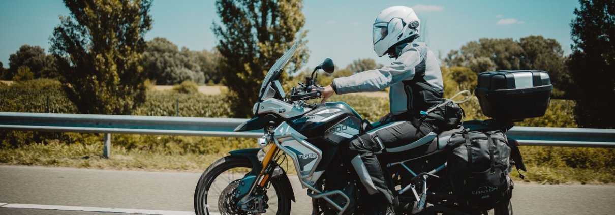 A racer in sportswear on a motorbike on a highway