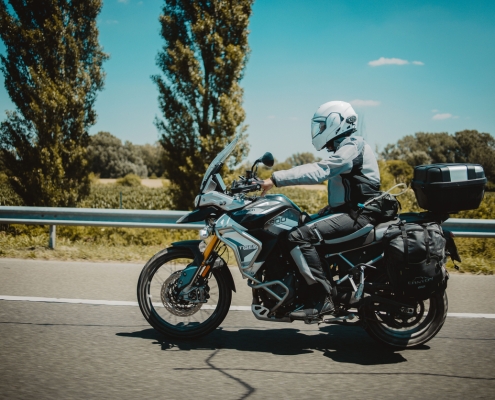 A racer in sportswear on a motorbike on a highway