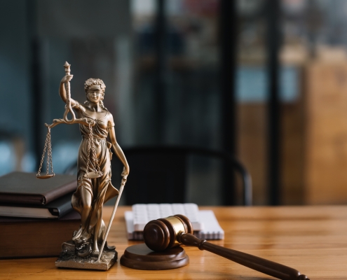 Statue of lady justice on desk of a judge or lawyer.