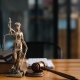 Statue of lady justice on desk of a judge or lawyer.