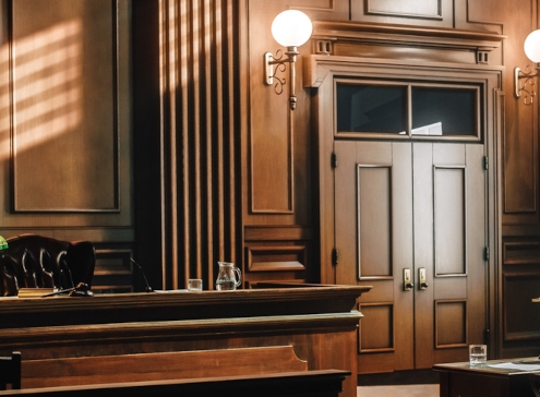 Empty American Style Courtroom. Supreme Court of Law and Justice Trial Stand. Courthouse Before Civil Case Hearing Starts. Grand Wooden Interior with Judge's Bench, Defendant's and Plaintiff's Tables.