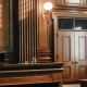 Empty American Style Courtroom. Supreme Court of Law and Justice Trial Stand. Courthouse Before Civil Case Hearing Starts. Grand Wooden Interior with Judge's Bench, Defendant's and Plaintiff's Tables.