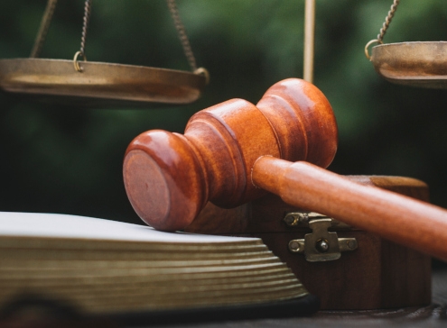 Business and lawyers discussing contract papers with brass scale on desk in office. Law, legal services, advice, justice and law concept picture with film grain effect