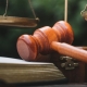 Business and lawyers discussing contract papers with brass scale on desk in office. Law, legal services, advice, justice and law concept picture with film grain effect