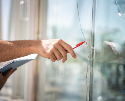 glass broken from a house by an accident, man checking to repair