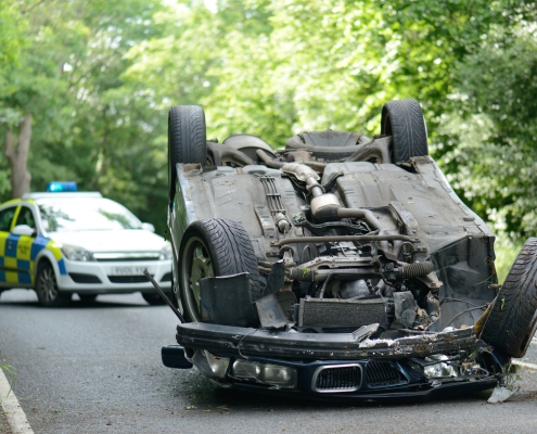 Car accident crash flipped upside down, road closed by police