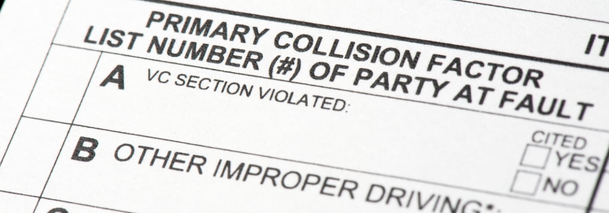 A close up view of a traffic collision report form. The portion of the report indicates which driver is at fault for the collision.