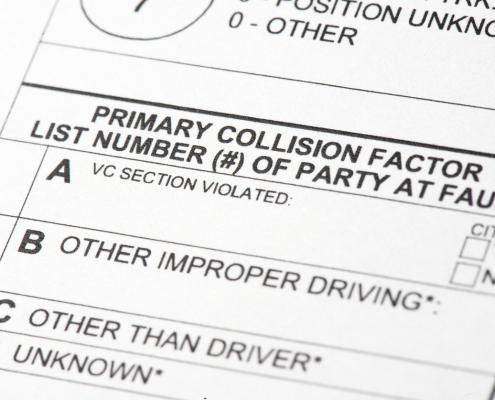 A close up view of a traffic collision report form. The portion of the report indicates which driver is at fault for the collision.